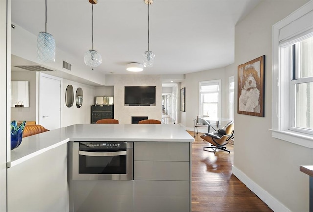 416 Commonwealth Ave Unit 317, Boston, MA 02215 - kitchen featuring light countertops, baseboards, visible vents, and dark wood-style floors