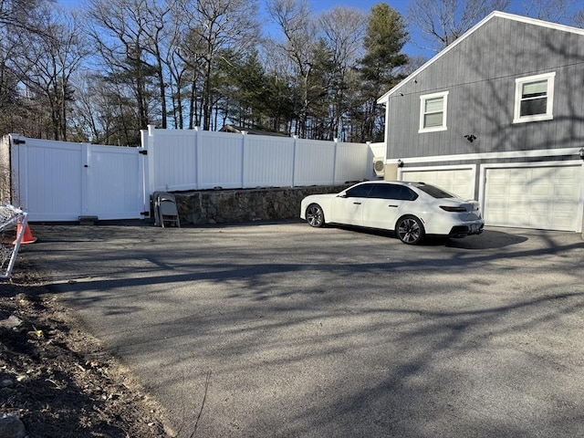 view of parking featuring a gate and fence