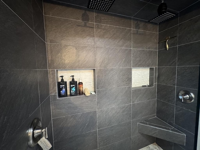 full bath featuring a tile shower