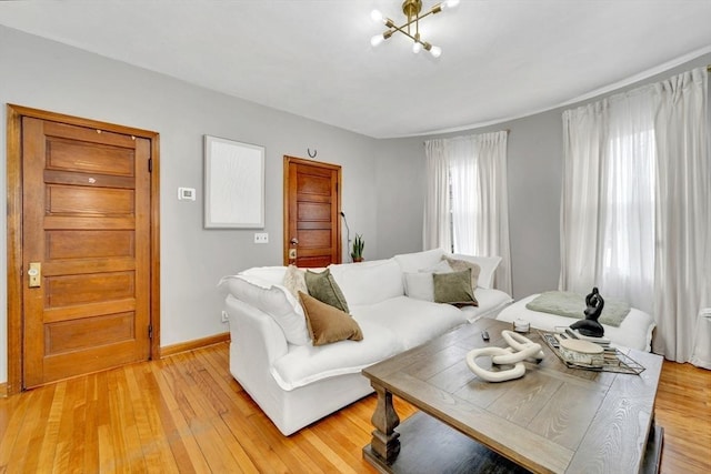 14 Halmstad, Worcester, MA 01607 - living room featuring light wood-type flooring, baseboards, and a chandelier