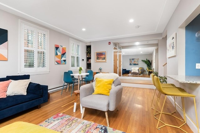 interior space with recessed lighting, a baseboard radiator, light wood-style floors, and stairway