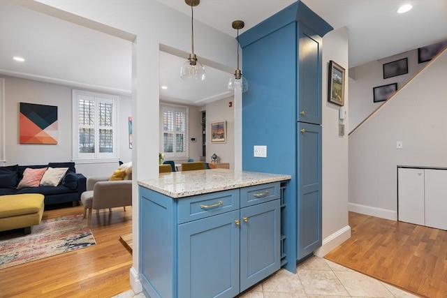 kitchen featuring light wood finished floors, open floor plan, and recessed lighting