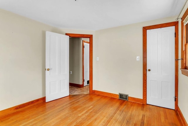 spare room with light hardwood / wood-style flooring