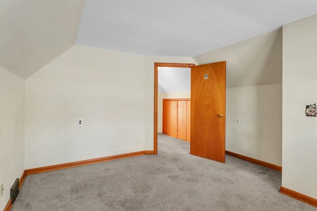 additional living space with light carpet and lofted ceiling