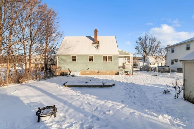 view of snow covered rear of property