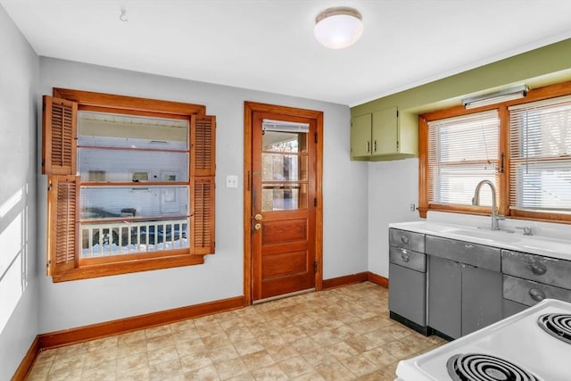 kitchen with sink, a wealth of natural light, and range