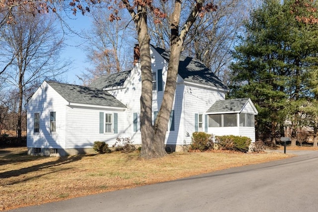 view of side of property with a sunroom