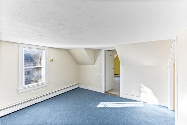 additional living space featuring carpet flooring, a textured ceiling, a baseboard radiator, and lofted ceiling