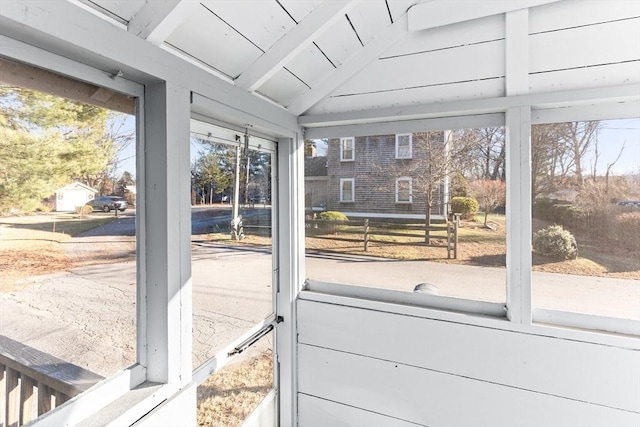 sunroom with vaulted ceiling with beams