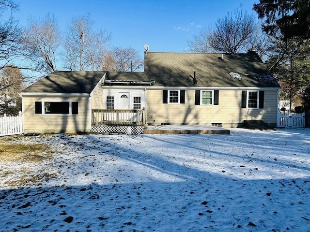 snow covered house with a deck