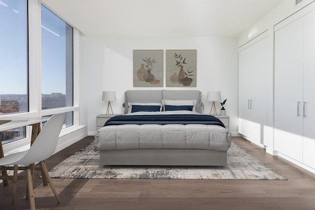 bedroom featuring wood finished floors and baseboards