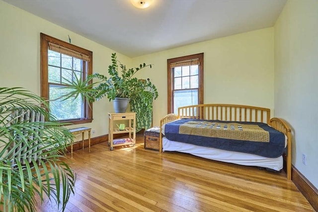 bedroom featuring baseboards and light wood finished floors