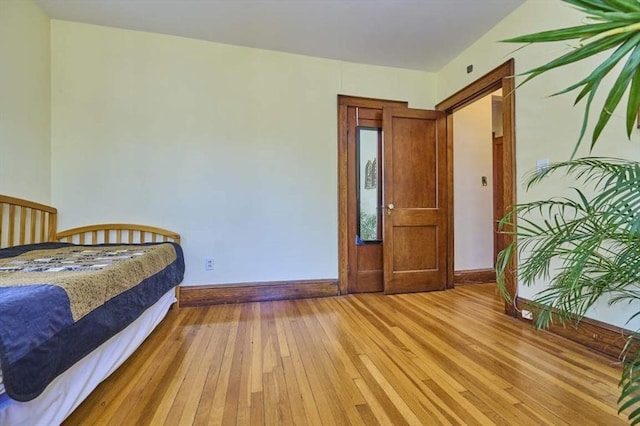 bedroom with baseboards and light wood-style flooring