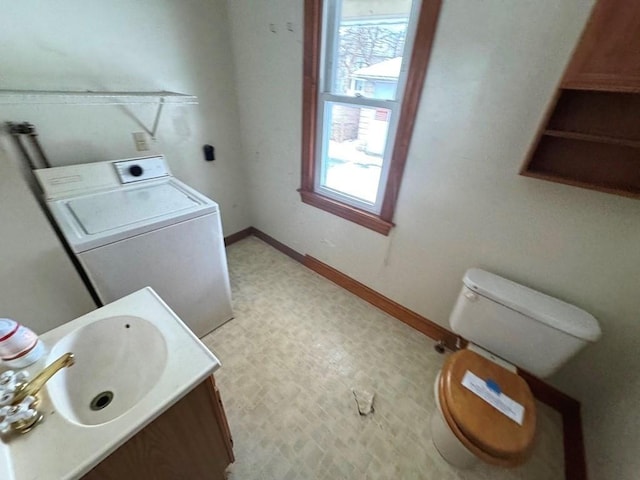 bathroom featuring washer / clothes dryer, plenty of natural light, baseboards, and tile patterned floors