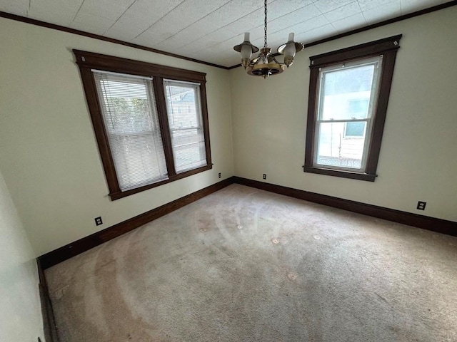 unfurnished room featuring light carpet, crown molding, baseboards, and an inviting chandelier