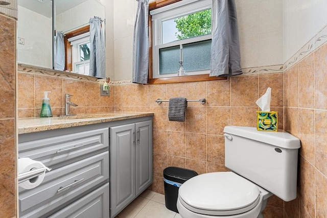 bathroom featuring tile walls, toilet, vanity, tile patterned flooring, and backsplash