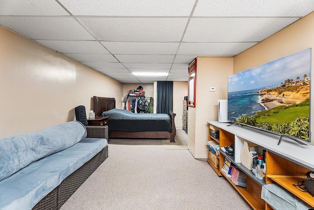 bedroom with a drop ceiling and carpet floors