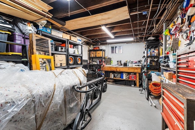 unfinished basement featuring a workshop area