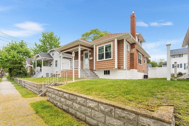view of front of home featuring a chimney, stairs, a porch, and central air condition unit
