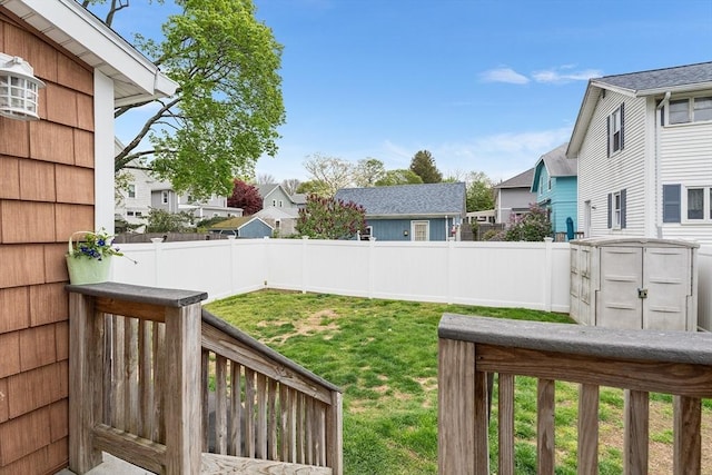 view of yard with a residential view and a storage unit