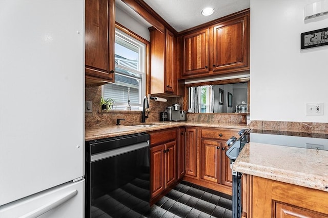 kitchen with freestanding refrigerator, a sink, black dishwasher, backsplash, and recessed lighting