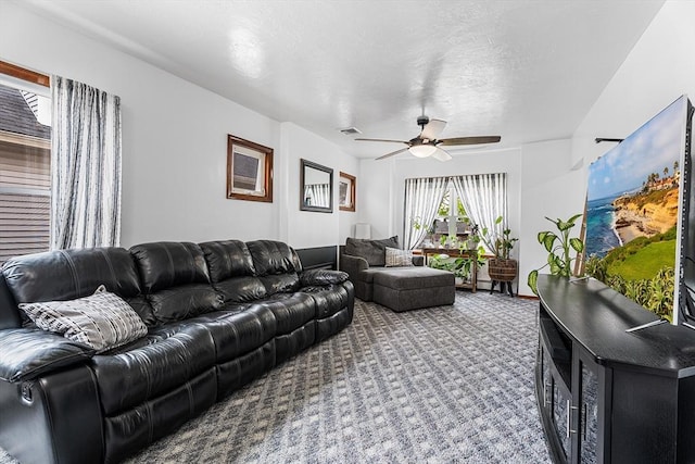 carpeted living room with ceiling fan