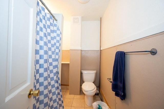 6-10 Walcott St, Southbridge, MA 01550 - full bathroom with toilet, tile patterned floors, curtained shower, and a wainscoted wall