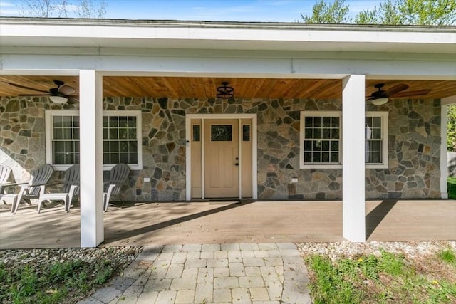 38 Rocky Hill Rd Unit B, Amesbury, MA 01913 - view of exterior entry featuring stone siding, ceiling fan, and a patio