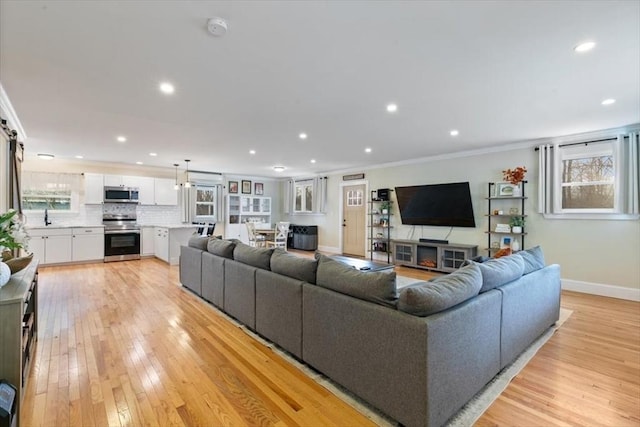 38 Rocky Hill Rd Unit B, Amesbury, MA 01913 - living room featuring baseboards, light wood finished floors, recessed lighting, and crown molding