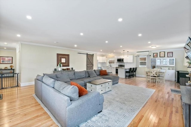38 Rocky Hill Rd Unit B, Amesbury, MA 01913 - living room featuring a barn door, recessed lighting, crown molding, light wood finished floors, and baseboards