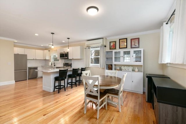 38 Rocky Hill Rd Unit B, Amesbury, MA 01913 - dining room with crown molding, light wood-style floors, a wall unit AC, and recessed lighting
