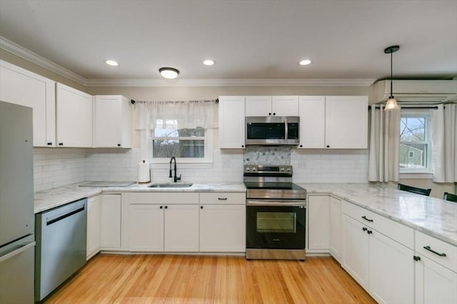 38 Rocky Hill Rd Unit B, Amesbury, MA 01913 - kitchen with stainless steel appliances, a sink, crown molding, white cabinetry, and light stone counters