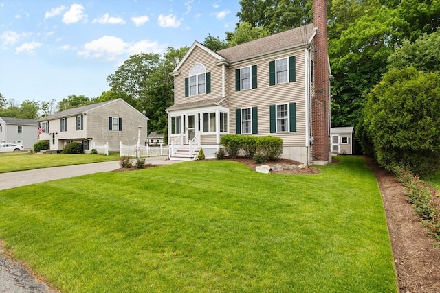 37 Railroad Ave, Whitman, MA 02382 - view of front facade with a chimney and a front yard