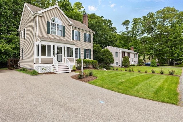 37 Railroad Ave, Whitman, MA 02382 - view of front facade with a chimney, a front lawn, a shingled roof, and view of wooded area
