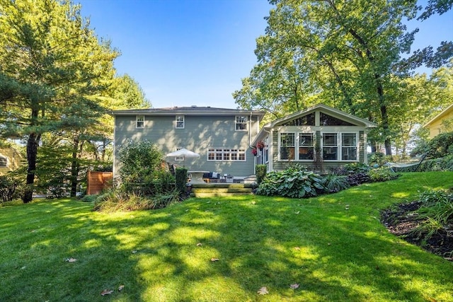 rear view of property featuring a yard