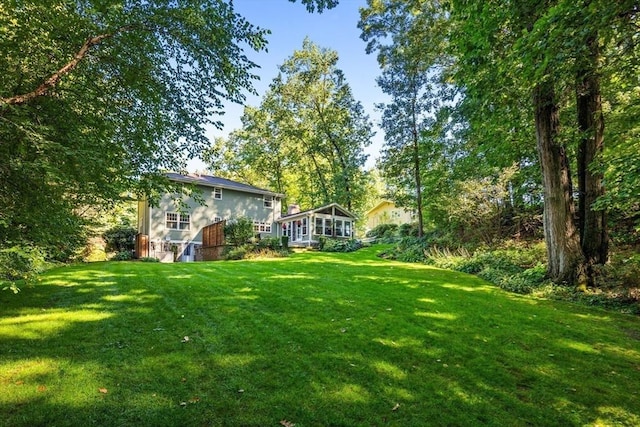 view of yard with a sunroom