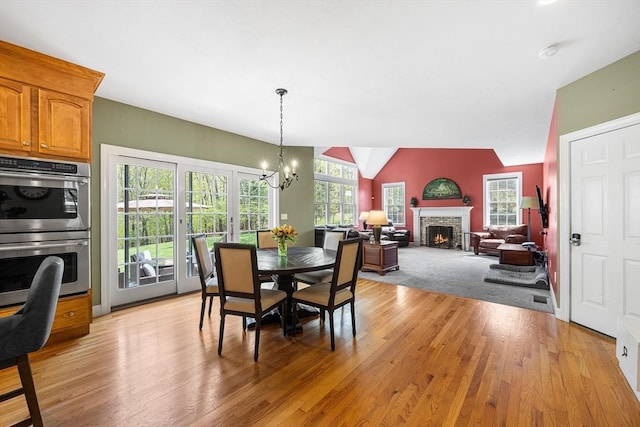 3 Emerson Way, Hopkinton, MA 01748 - dining room featuring a chandelier, light wood-style flooring, a fireplace with flush hearth, and lofted ceiling