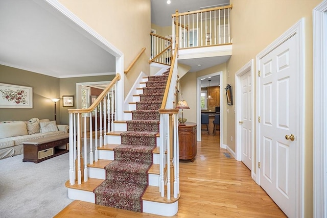 3 Emerson Way, Hopkinton, MA 01748 - stairs with wood finished floors, crown molding, a towering ceiling, and baseboards