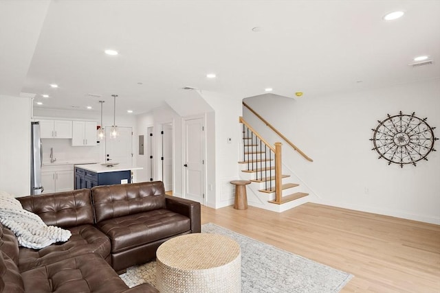 50 N Payne St Unit 2, Quincy, MA 02169 - living room featuring recessed lighting, light wood-type flooring, stairway, and baseboards