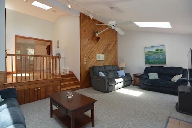 13 N Grove St, Foxboro, MA 02035 - living room with a skylight, carpet floors, a ceiling fan, wooden walls, and high vaulted ceiling