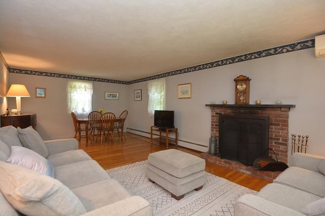13 N Grove St, Foxboro, MA 02035 - living room featuring wood finished floors, a fireplace, a baseboard radiator, and a wall unit AC