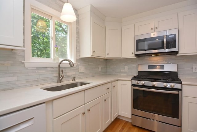 13 N Grove St, Foxboro, MA 02035 - kitchen featuring stainless steel appliances, white cabinets, and decorative backsplash