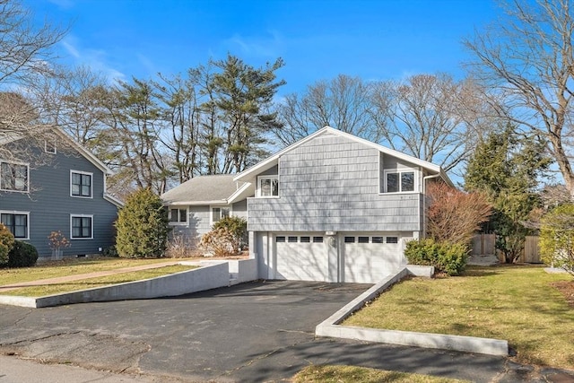 view of home's exterior with a garage and a yard