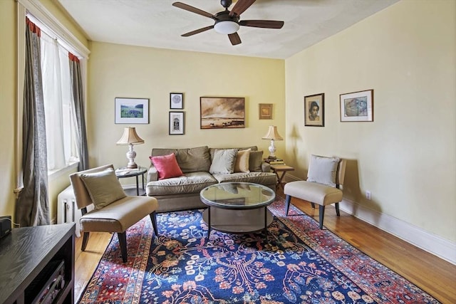 living room featuring hardwood / wood-style floors and ceiling fan