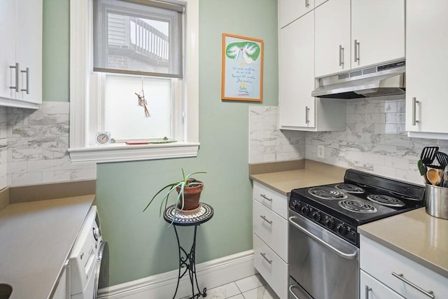 kitchen with electric range oven, a wealth of natural light, and white cabinets