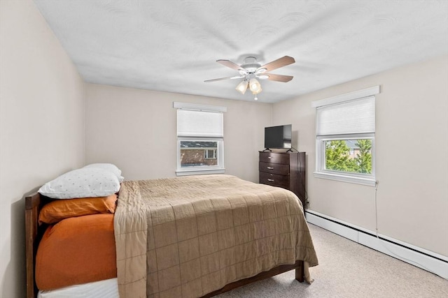 bedroom featuring carpet floors, a baseboard radiator, and a ceiling fan