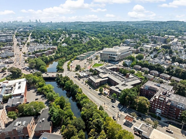 birds eye view of property with a water view and a view of city