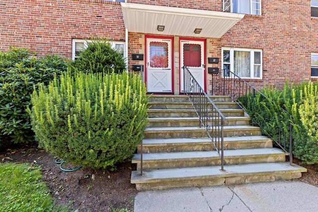 doorway to property with brick siding