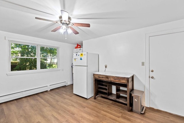 interior space with light wood-type flooring, a baseboard radiator, and a ceiling fan