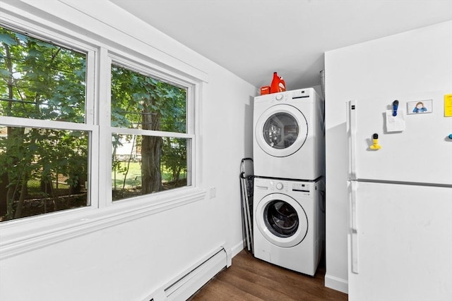 clothes washing area with laundry area, baseboards, dark wood finished floors, stacked washing maching and dryer, and a baseboard heating unit